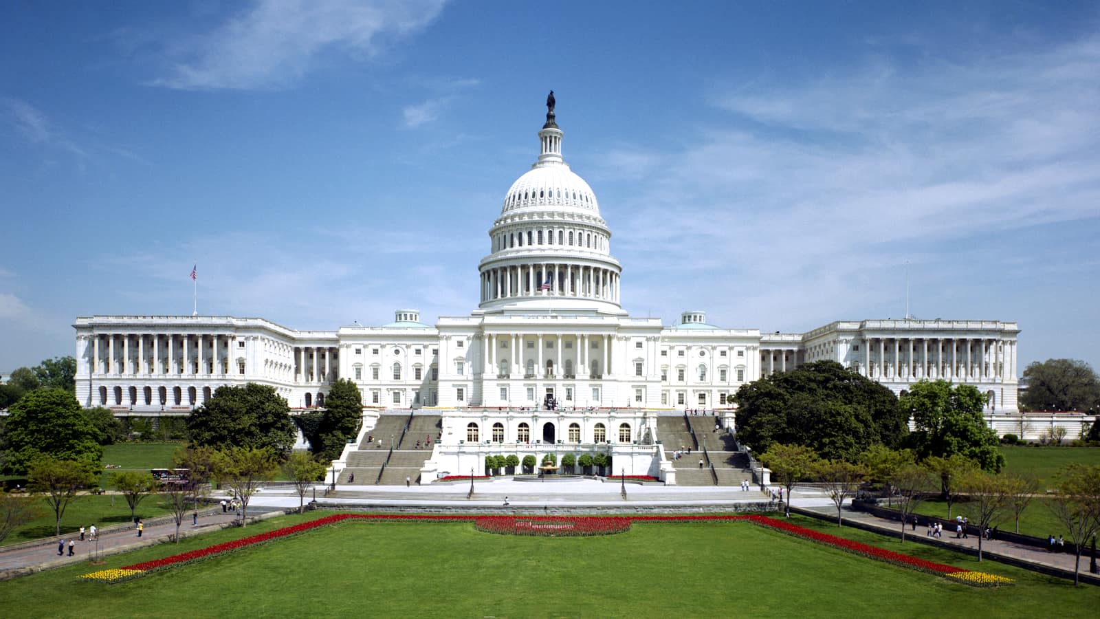 The west front of the United States Capitol under a clear sky.