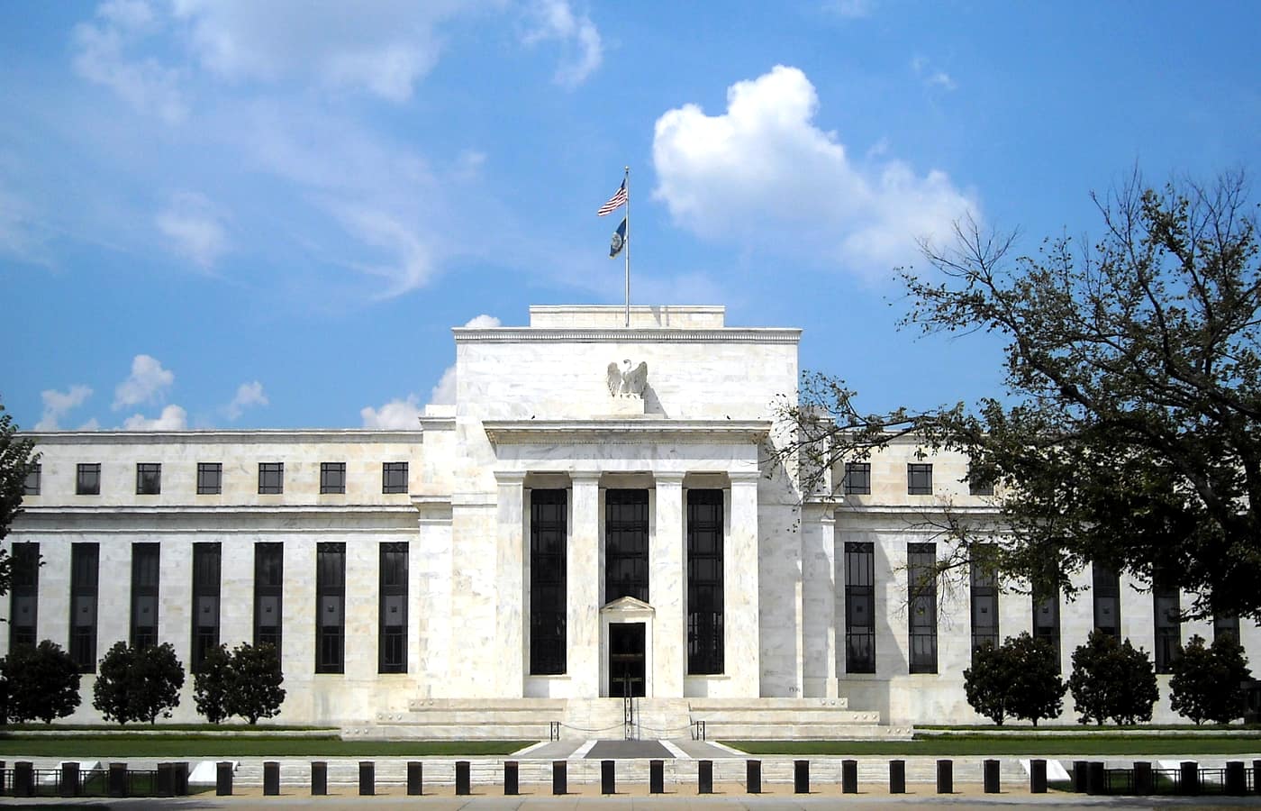The Marriner S. Eccles Federal Reserve Board building in Washington under a blue sky.