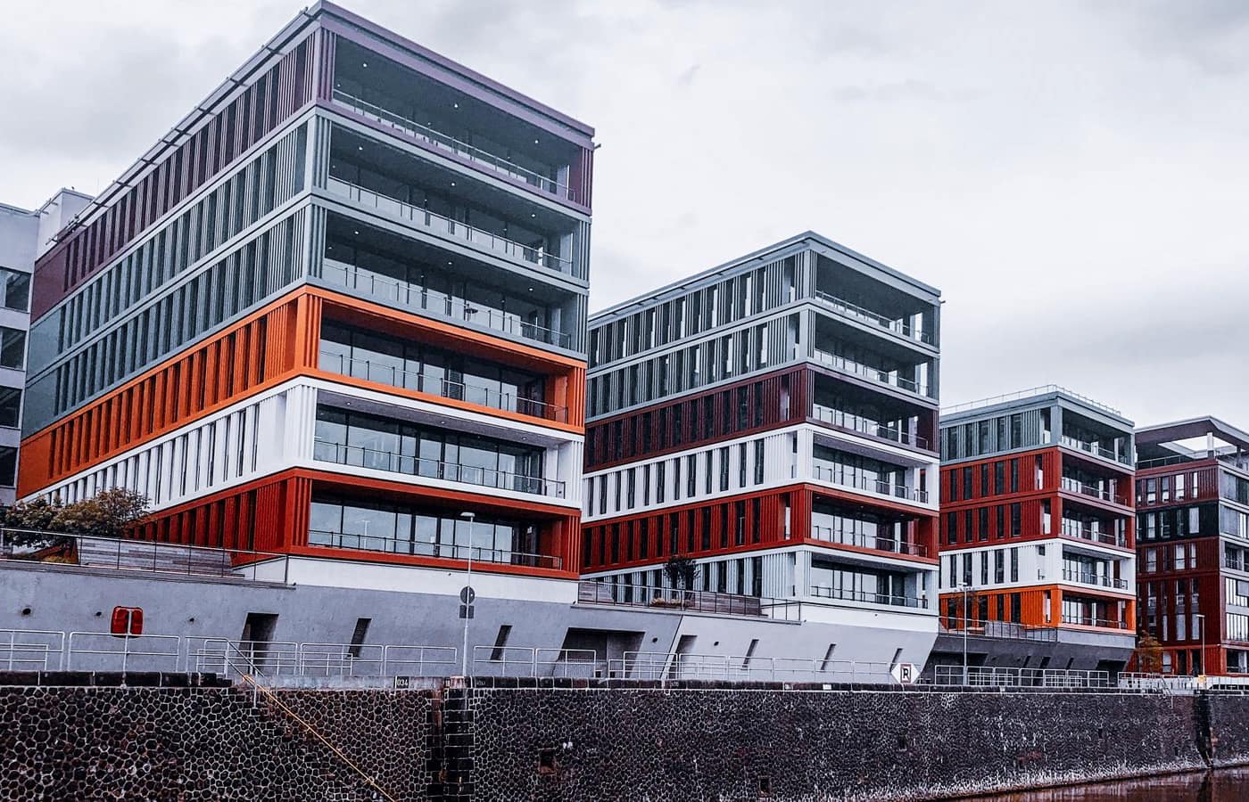 A modern mixed-use building complex with staggered floors and balconies